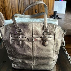 Coach Platinum purse. 3 pockets inside, 1 is zippered. 2 stains on the inside